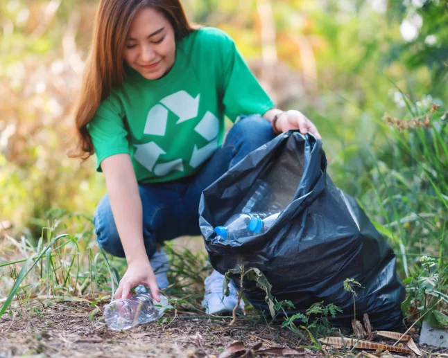 Asian volunteer picking plastic bag Asian volunteer picking plastic bag